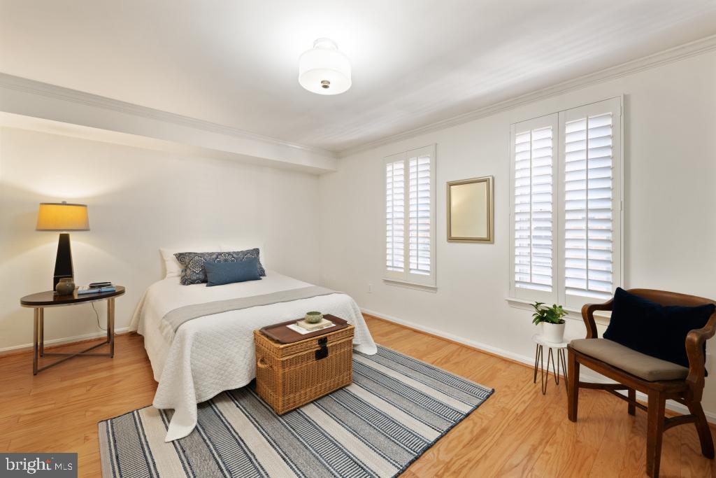 1441 A Street Northeast, Unit 1441 Washington, DC 20002 - Photo 9 of 11 a bedroom with a bed and wooden floor