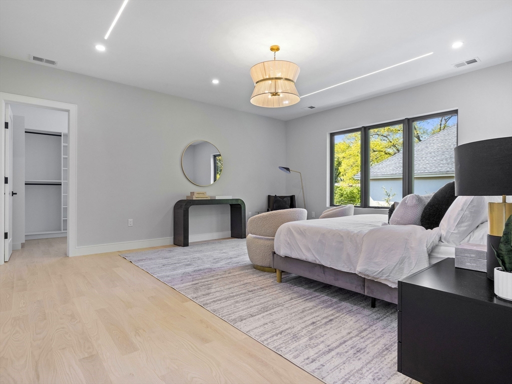 54 Redwood Road Newton, MA 02459 - Photo 27 of 42 a bedroom with a bed and a chandelier