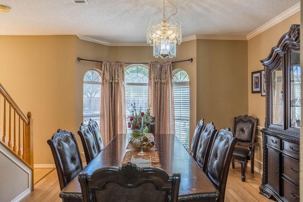 4113 Bluffpoint Road Rowlett, TX 75088 - Photo 9 of 39 a view of a dining room with furniture window and wooden floor