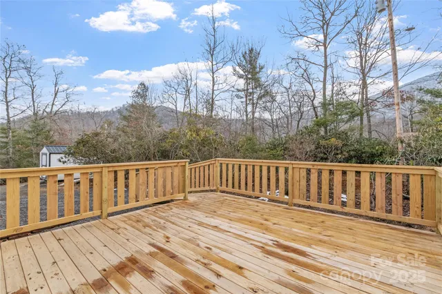 a balcony with wooden floor and trees