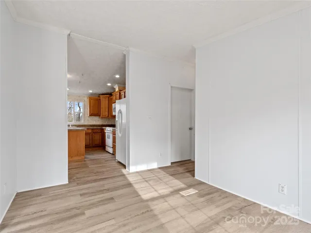 a view of a kitchen with a sink and a refrigerator