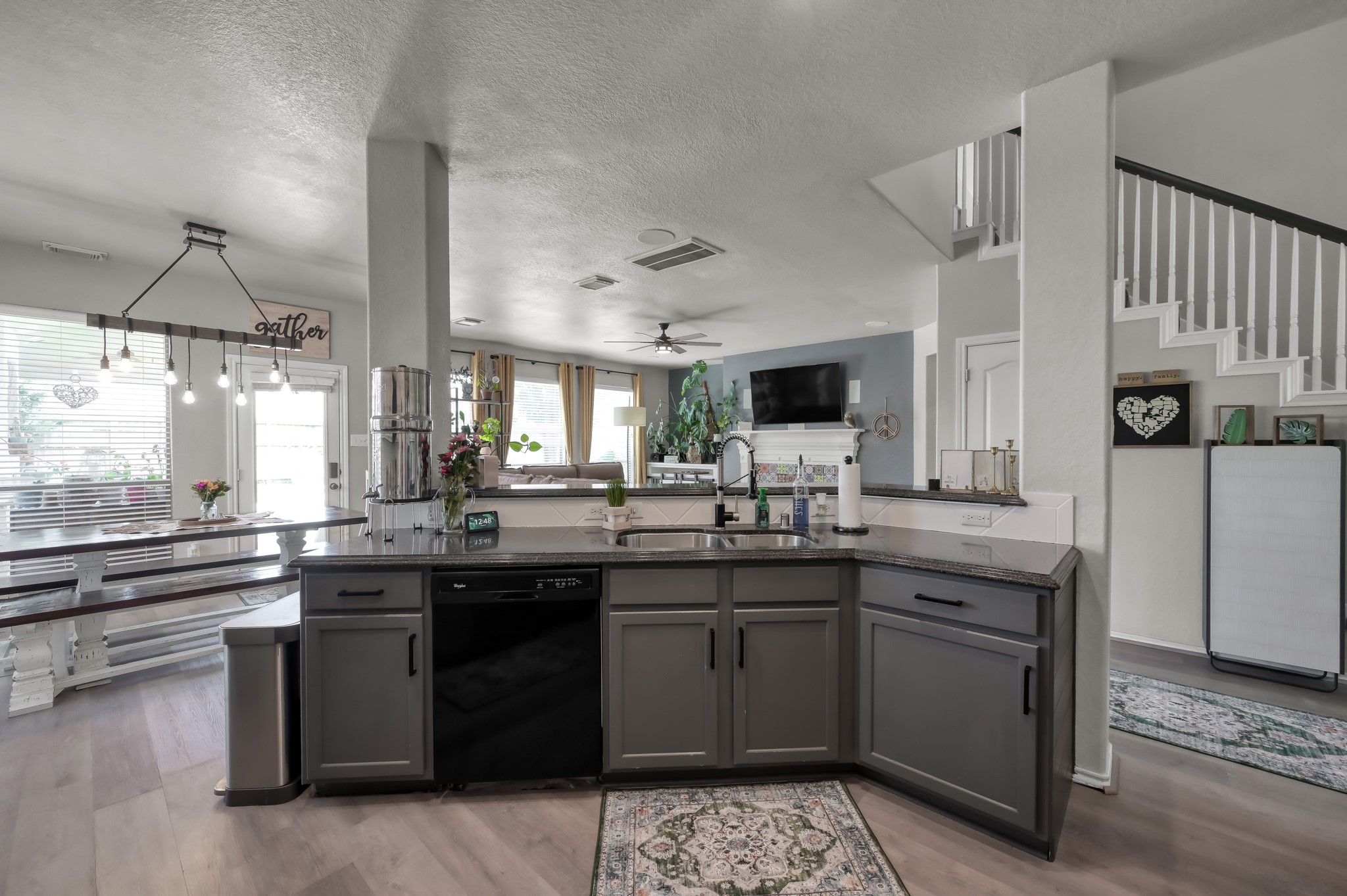 28522 Misty Cliff Lane Spring, TX 77386 - Photo 4 of 12 Open-concept kitchen overlooking the dining and living areas, complete with breakfast bar seating and updated finishes. Spacious layout creates the perfect gathering space for family and guests.
