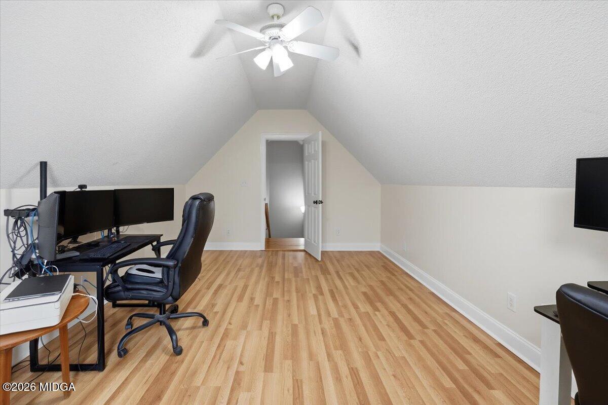 557 Aarons Circle Gray, GA 31032 - Photo 27 of 36 a view of a workspace with furniture and a ceiling fan