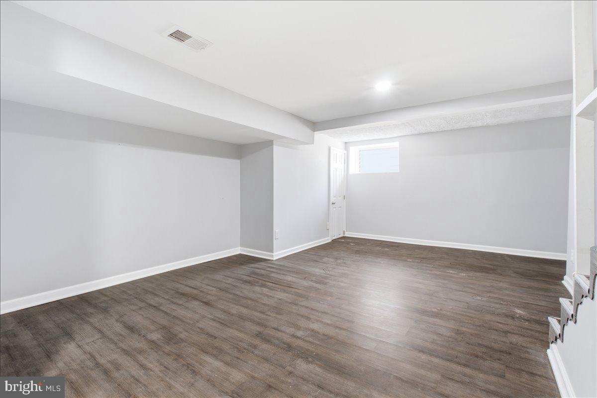 1231 North Potomac Street Baltimore, MD 21213 - Photo 24 of 25 a view of an empty room with wooden floor