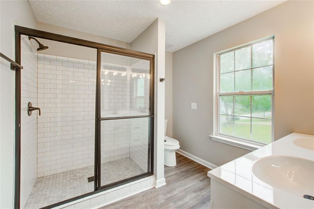 4110 Ridgebrook Bend Cumming, GA 30028 - Photo 29 of 49 a bathroom with a bathtub and a shower