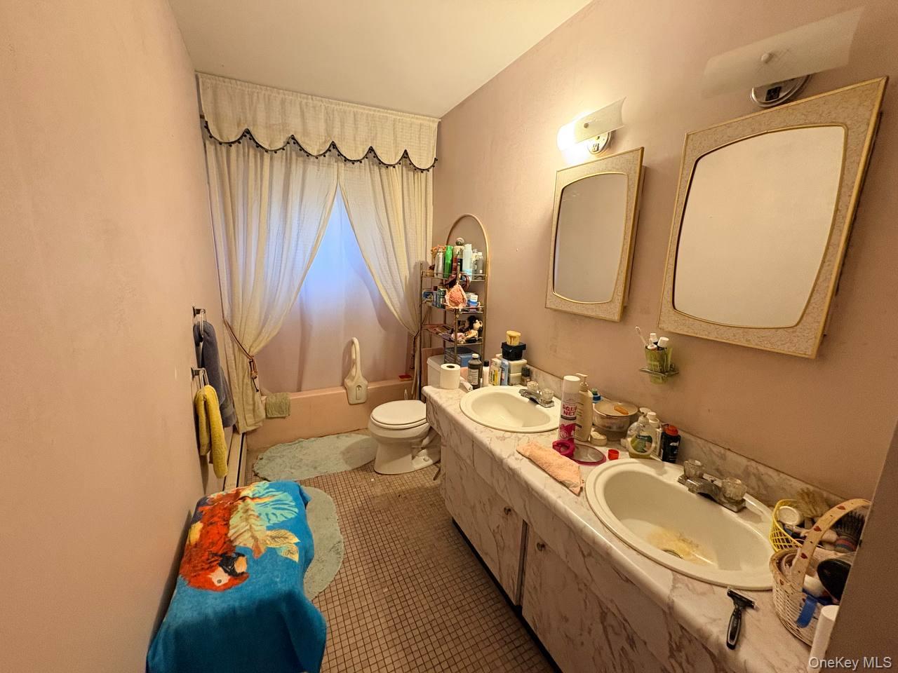 66 40th Street Islip, NY 11751 - Photo 11 of 12 a bathroom with a double vanity sink mirror and toilet