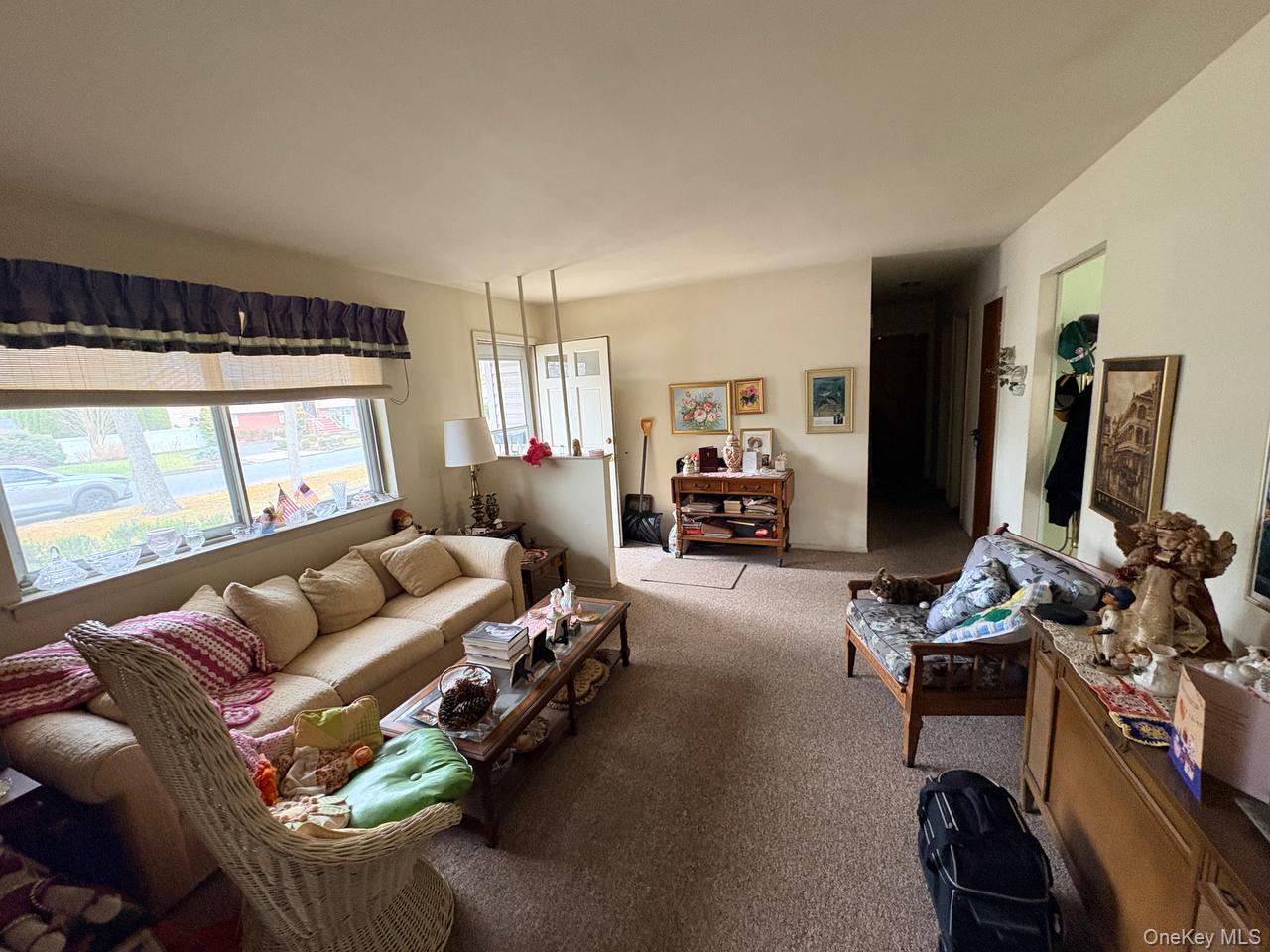 66 40th Street Islip, NY 11751 - Photo 2 of 12 a living room with furniture fireplace and a large window