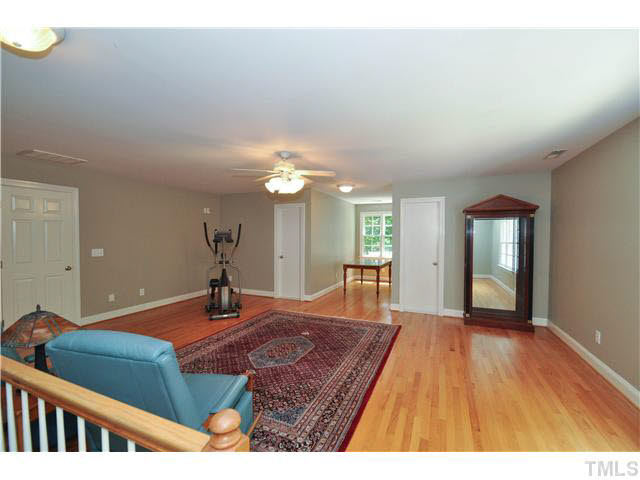 4209 White Chapel Way Raleigh, NC 27615 - Photo 16 of 25 The expansive bonus room features hardwood flooring, upgraded lighting and ceiling fan, walk-in storage and walk-in closets.