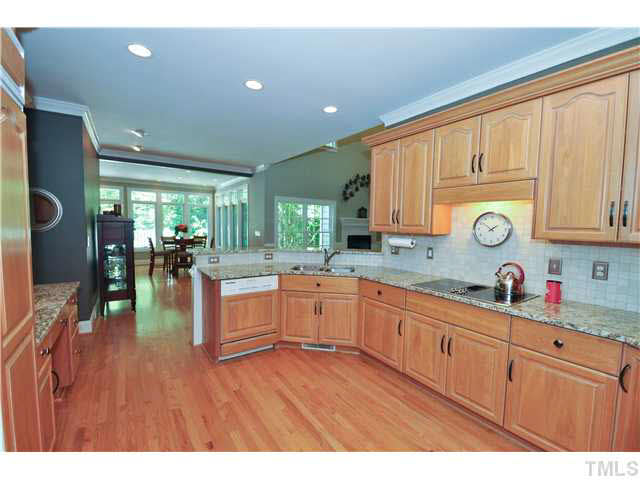 4209 White Chapel Way Raleigh, NC 27615 - Photo 10 of 25 The spectacular kitchen offers a place to gather with friends and family to enjoy the art of cooking. Granite counter tops, smooth ceilings, cherry cabinetry, stainless steel appliances, wood paneled refrigerator to blend,
