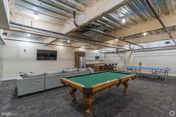a kitchen with a table chairs and refrigerator