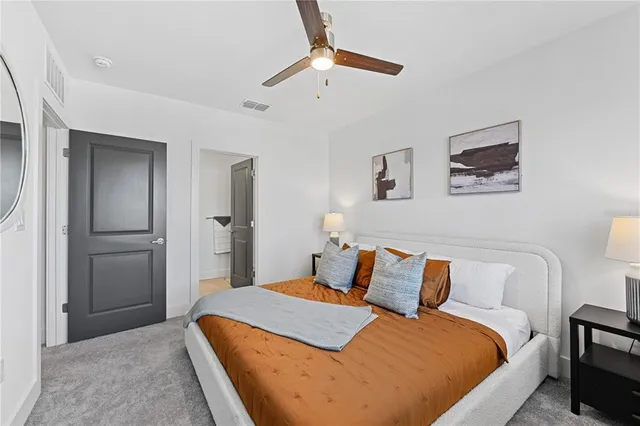 a bedroom with bed and a chandelier