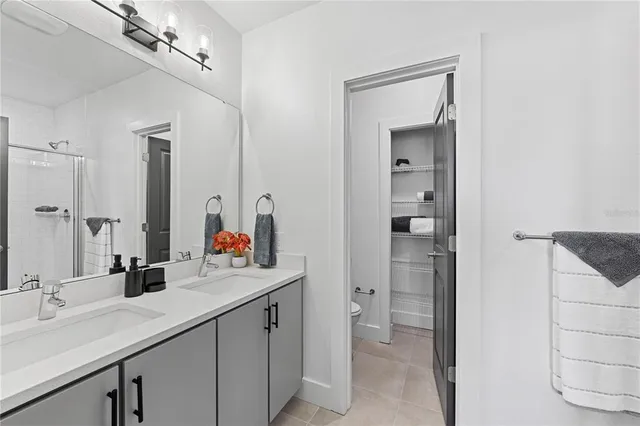 a bathroom with a sink double vanity and a mirror