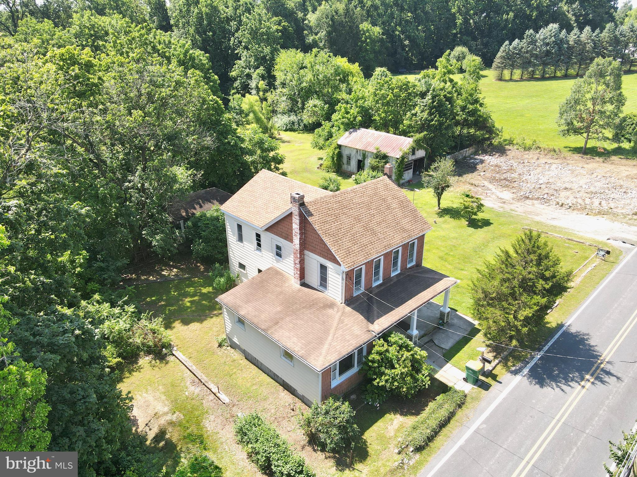 an aerial view of a house with a yard basket ball court and outdoor seating