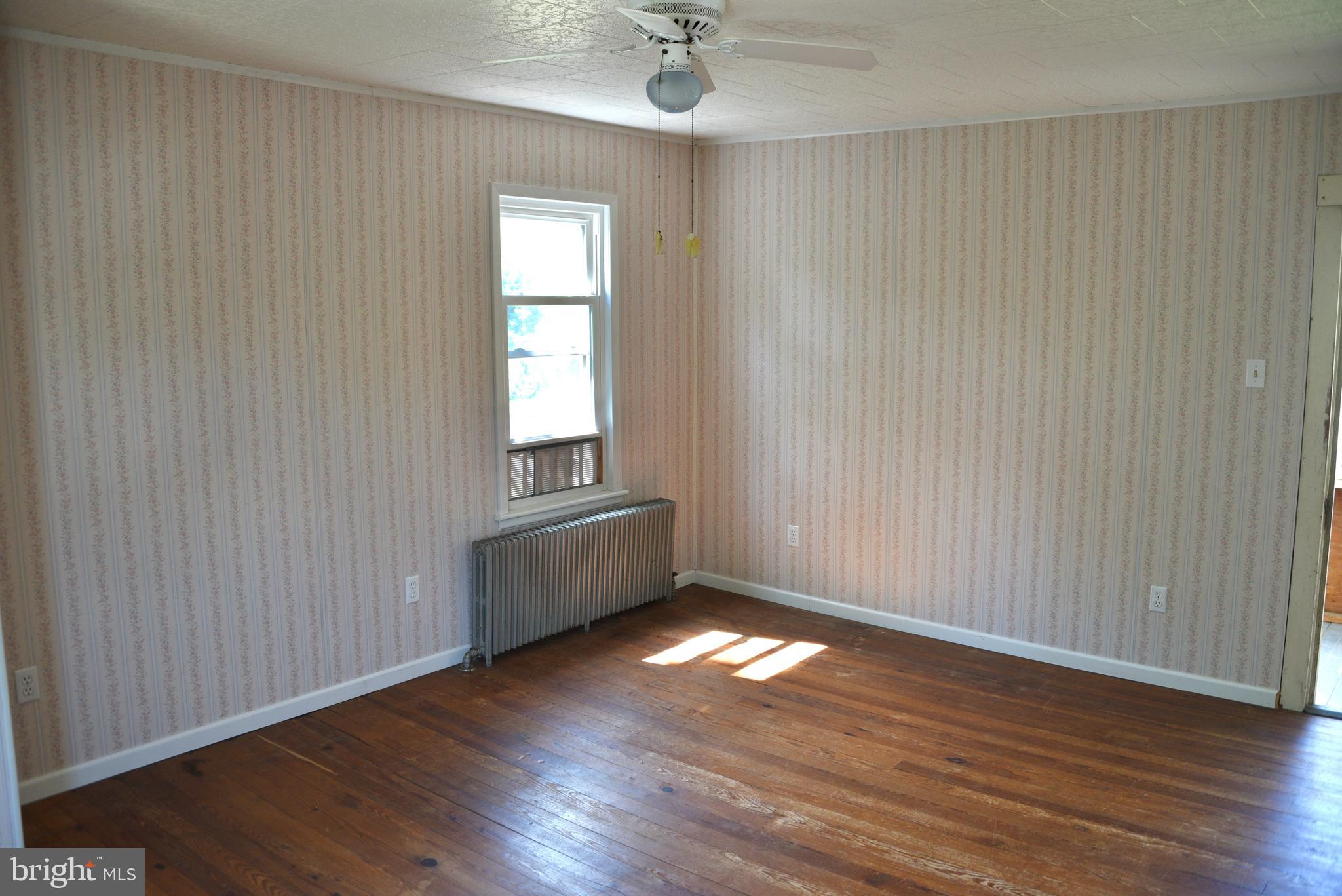 722 Mohns Hill Road Reading, PA 19608 - Photo 16 of 46 an empty room with wooden floor and windows