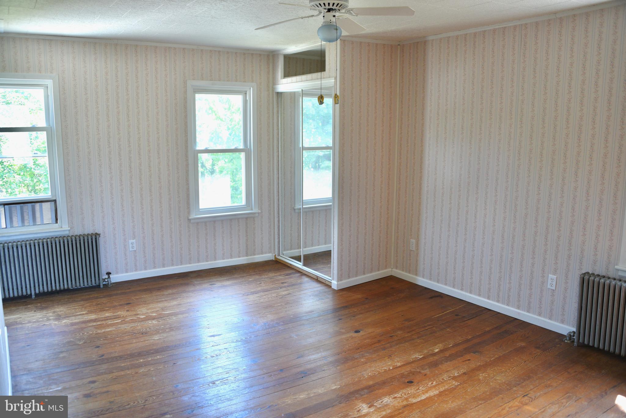 722 Mohns Hill Road Reading, PA 19608 - Photo 17 of 46 an empty room with wooden floor and windows