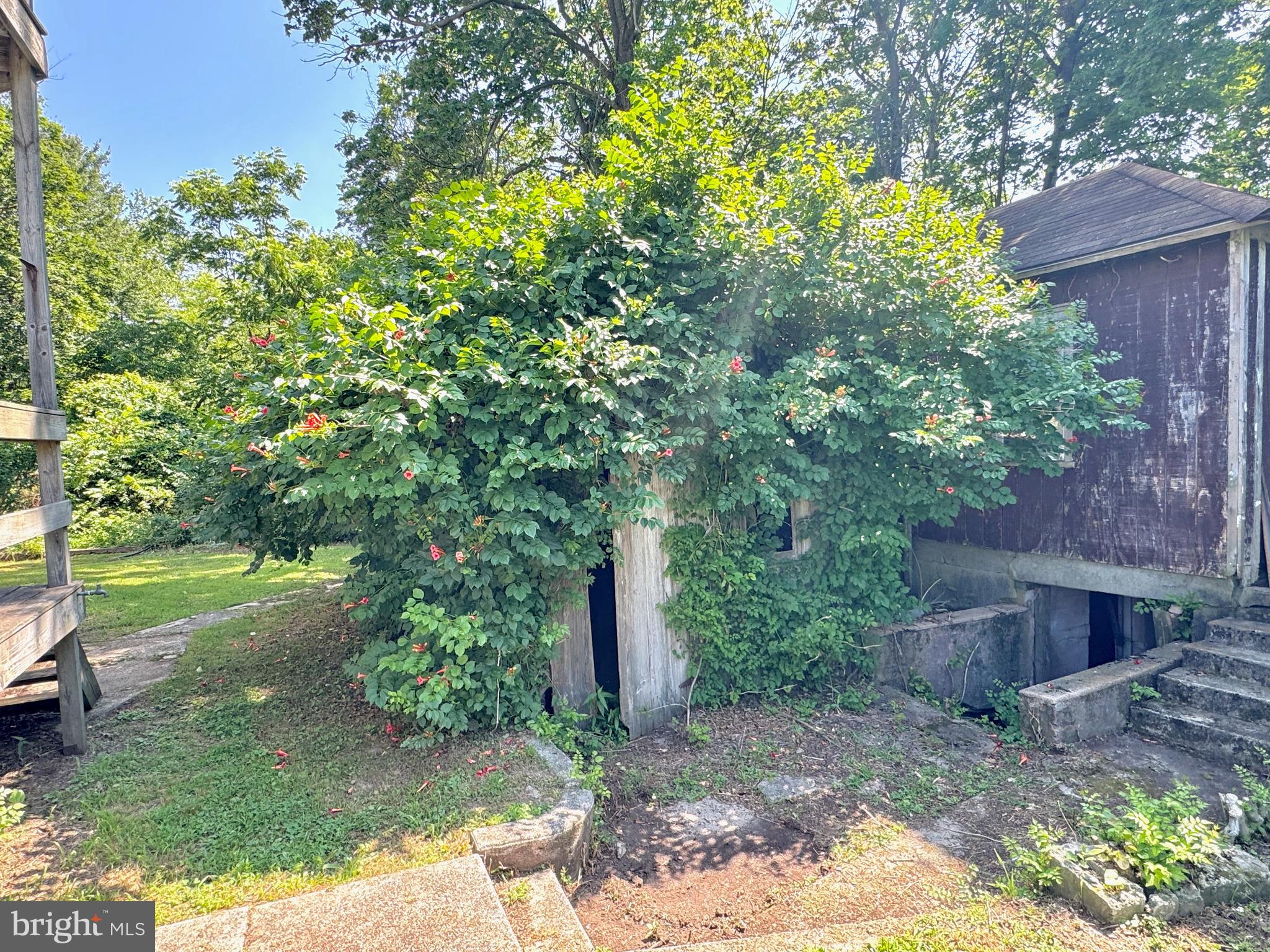 722 Mohns Hill Road Reading, PA 19608 - Photo 39 of 46 a backyard of a house with a garden and outdoor seating