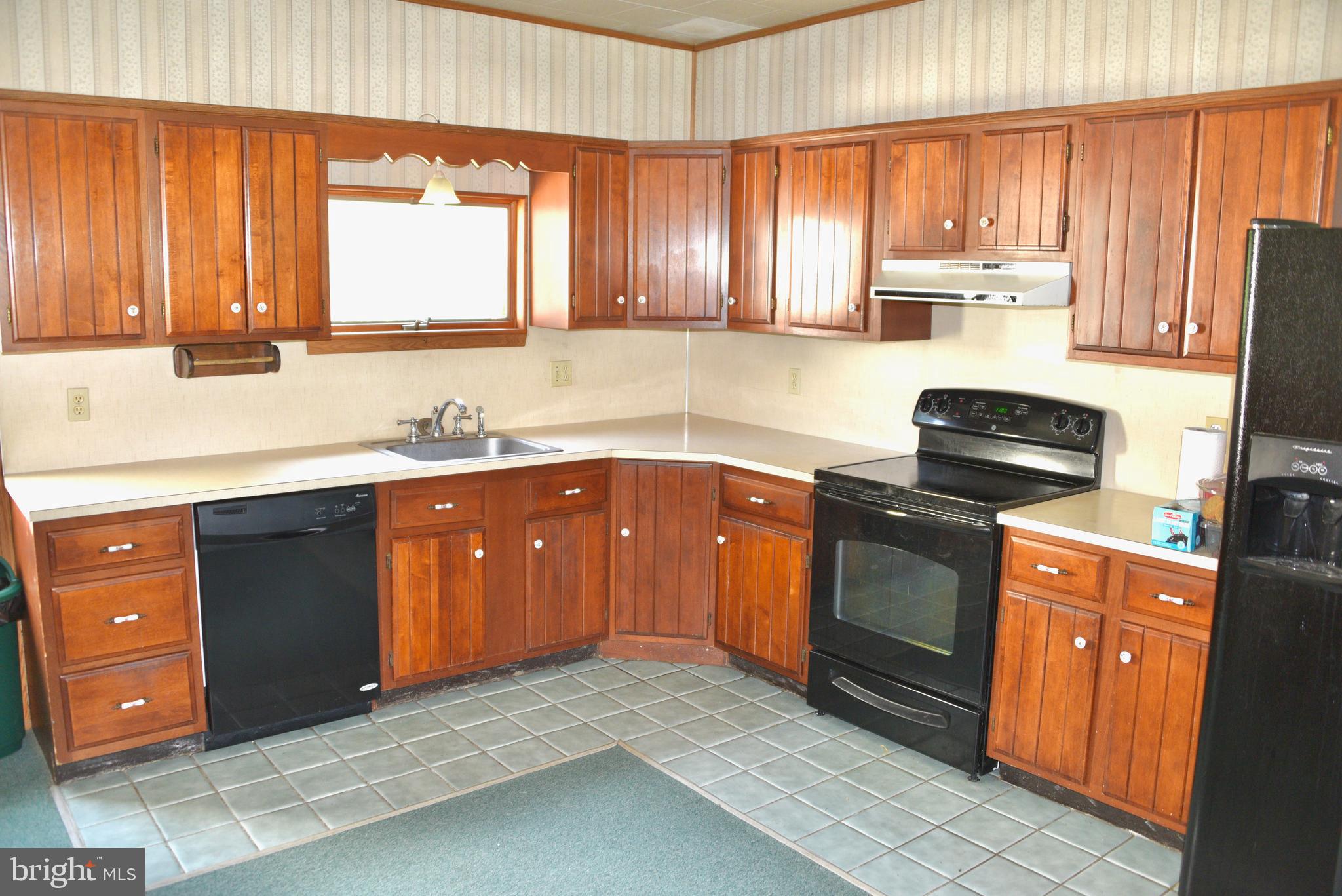 722 Mohns Hill Road Reading, PA 19608 - Photo 9 of 46 a kitchen with stainless steel appliances granite countertop wooden cabinets a stove a sink and a window