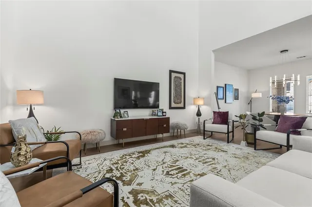 a living room with furniture a flat screen tv and a couch