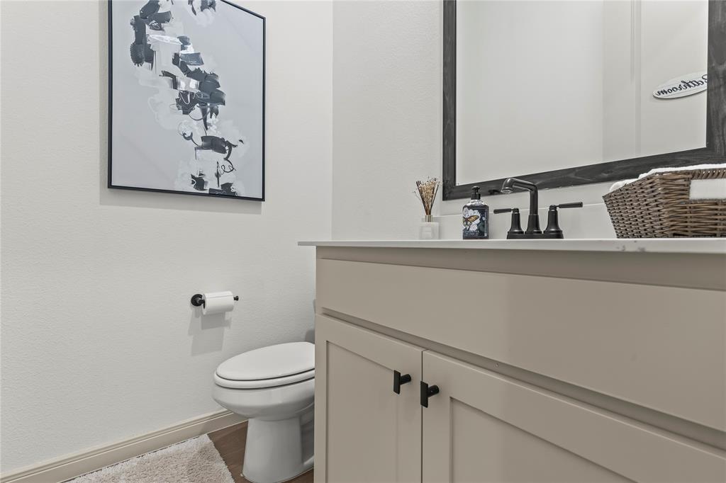15627 Rue Drive Frisco, TX 75033 - Photo 14 of 35 a bathroom with a toilet a sink and mirror
