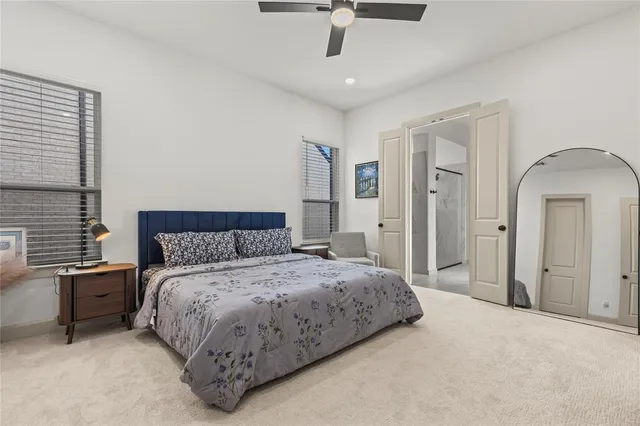 a bedroom with a bed dresser and window