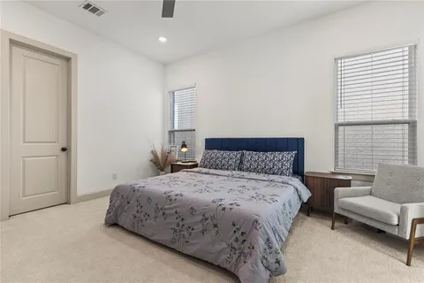 a bedroom with a bed and a couch