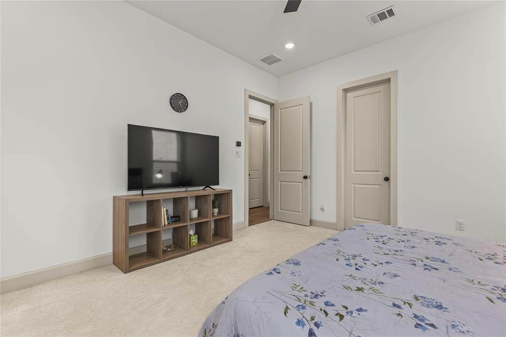 15627 Rue Drive Frisco, TX 75033 - Photo 19 of 35 a bedroom with a bed and a flat screen tv
