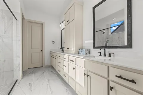 a spacious bathroom with double sink and a mirror