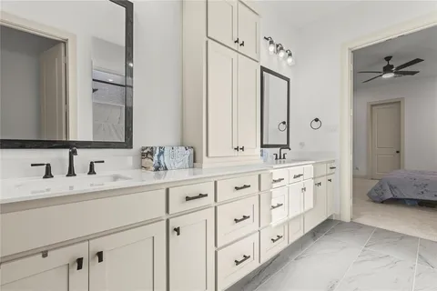 a bathroom with double sink and a mirror