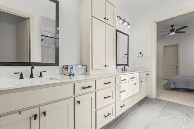 a bathroom with double sink and a mirror