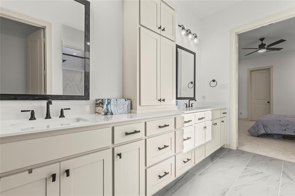 15627 Rue Drive Frisco, TX 75033 - Photo 21 of 35 a bathroom with double sink and a mirror