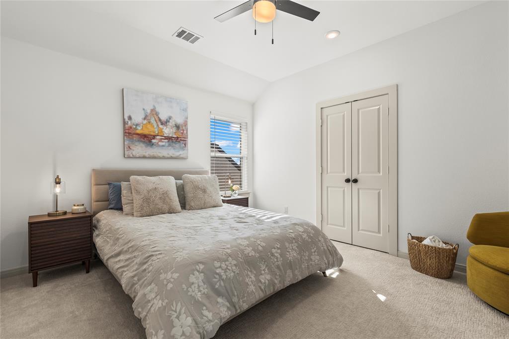 15627 Rue Drive Frisco, TX 75033 - Photo 25 of 35 a bedroom with a bed and a chandelier