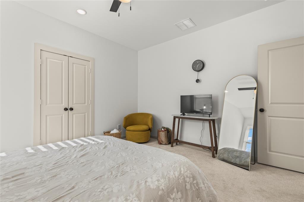 15627 Rue Drive Frisco, TX 75033 - Photo 26 of 35 a bedroom with a bed and a flat screen tv