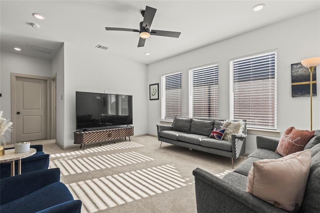15627 Rue Drive Frisco, TX 75033 - Photo 27 of 35 a living room with furniture and a flat screen tv