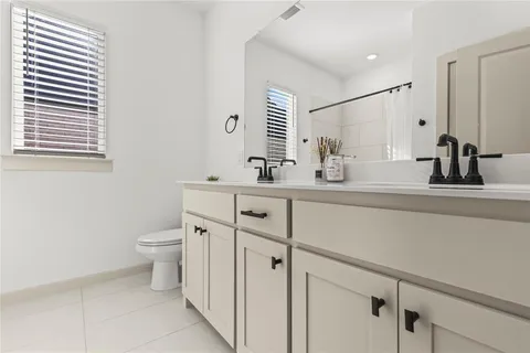 a bathroom with a sink toilet and mirror