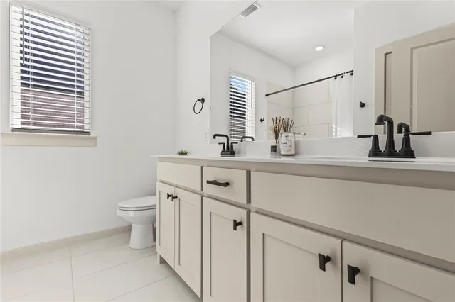 a bathroom with a sink toilet and mirror