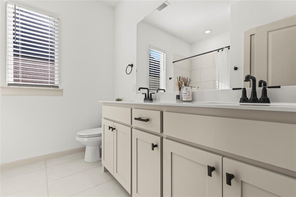 15627 Rue Drive Frisco, TX 75033 - Photo 29 of 35 a bathroom with a sink toilet and mirror