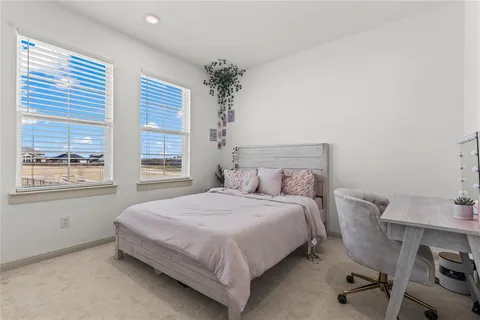 a bedroom with a bed and a table with chair