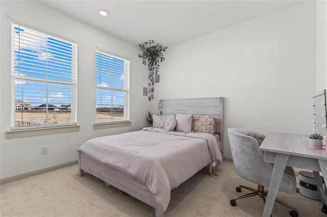 a bedroom with a bed and a table with chair