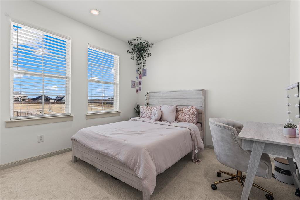 15627 Rue Drive Frisco, TX 75033 - Photo 32 of 35 a bedroom with a bed and a table with chair