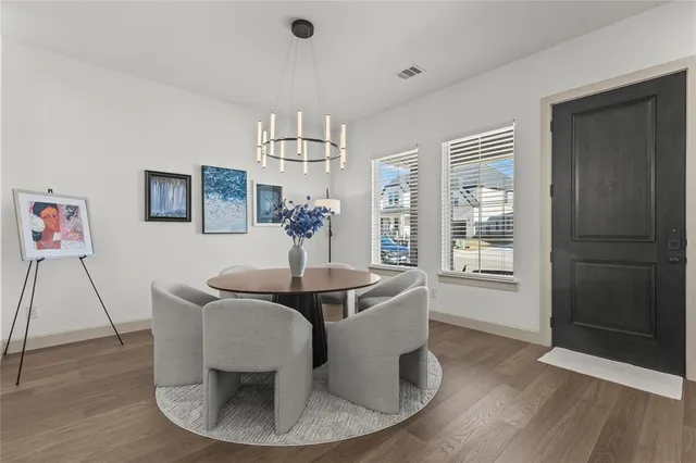 a view of a dining room with furniture wooden floor and chandelier