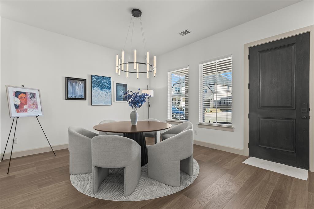 15627 Rue Drive Frisco, TX 75033 - Photo 9 of 35 a view of a dining room with furniture wooden floor and chandelier