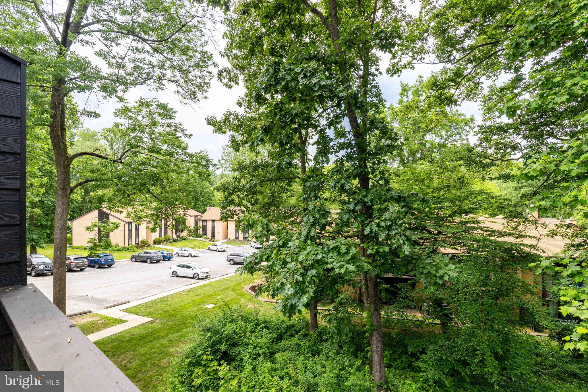 704 Painters Crossing, Unit 704 Chadds Ford, PA 19317 - Photo 26 of 34 a view of yard with swimming pool and trees