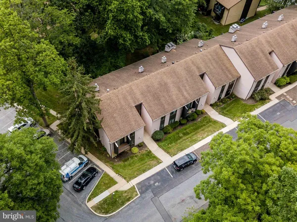 an aerial view of a house with a garden and trees