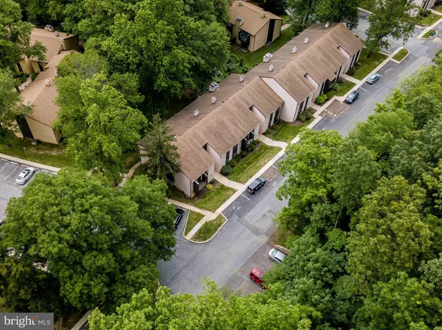 an aerial view of a house with a yard and garden