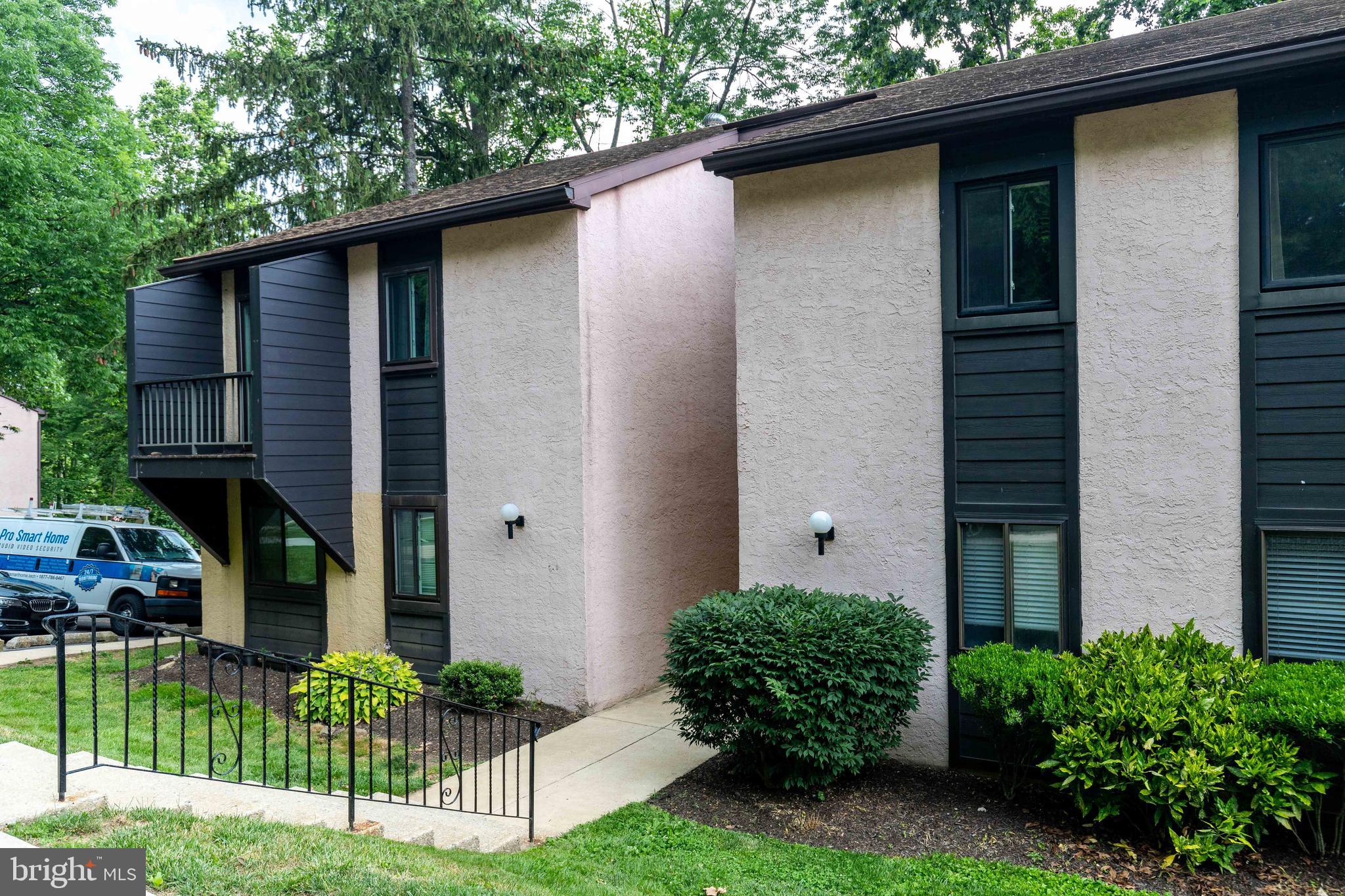 704 Painters Crossing, Unit 704 Chadds Ford, PA 19317 - Photo 3 of 34 a front view of a house with garden