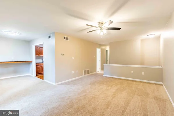 a view of an empty room with a ceiling fan