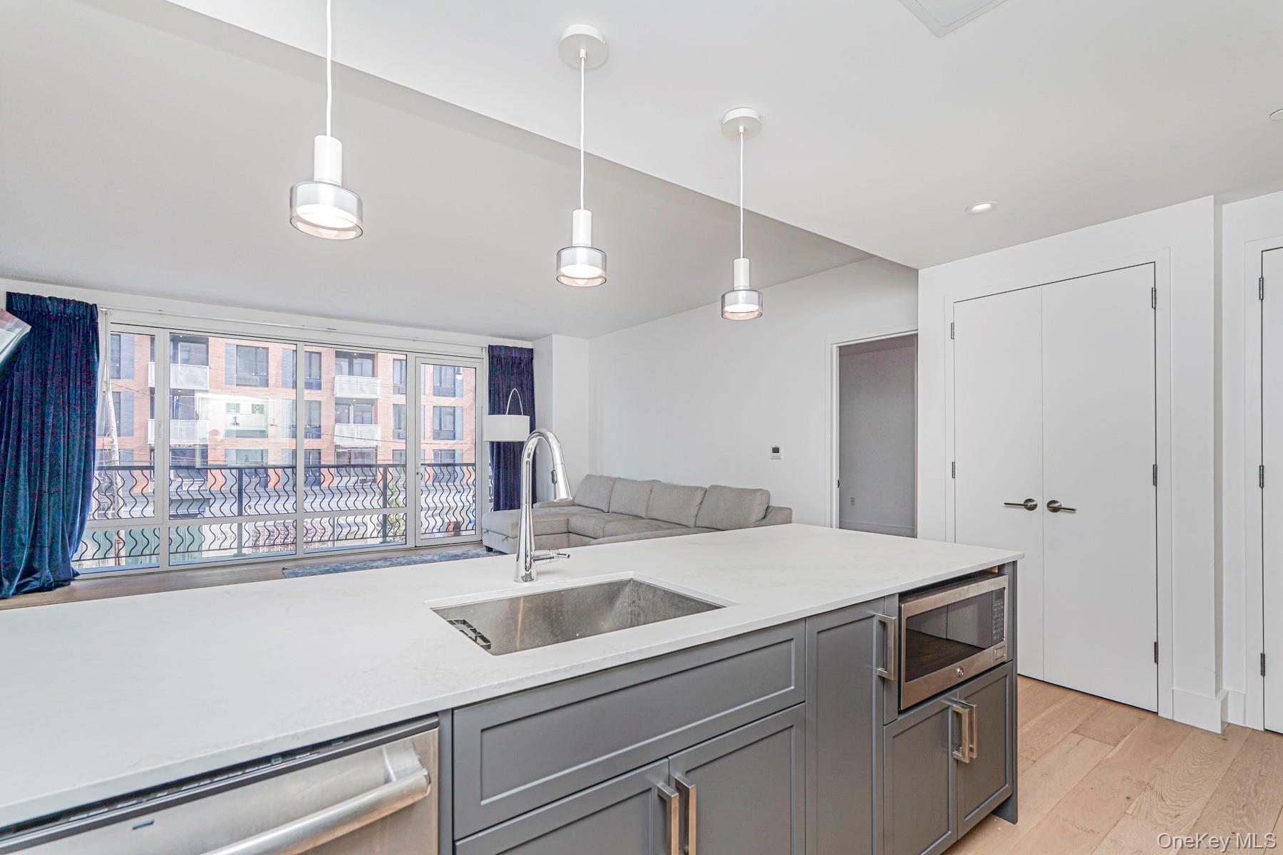 133 Beach 116th Street, Unit 2C Queens, NY 11694 - Photo 10 of 35 a kitchen with a sink and a window