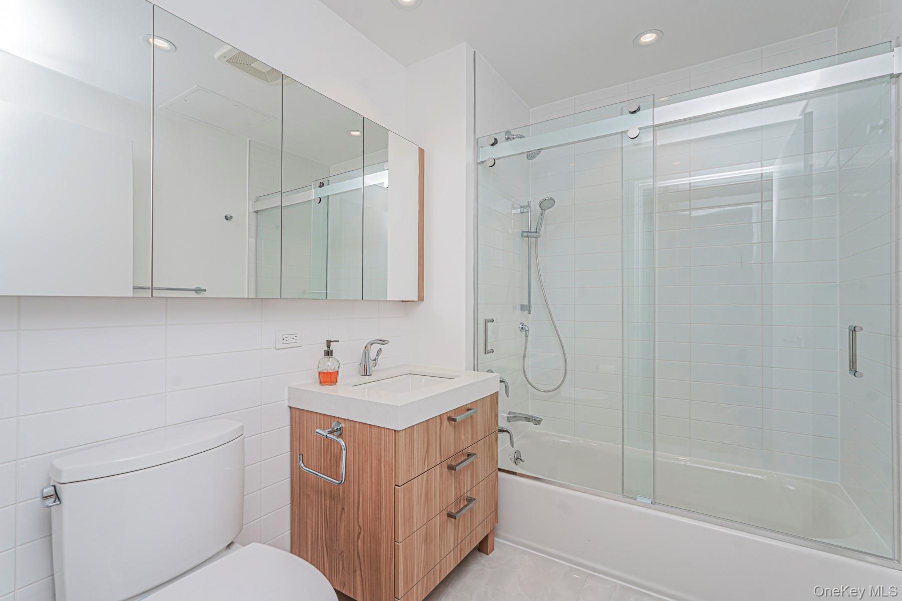 133 Beach 116th Street, Unit 2C Queens, NY 11694 - Photo 21 of 35 a bathroom with a sink a toilet and shower