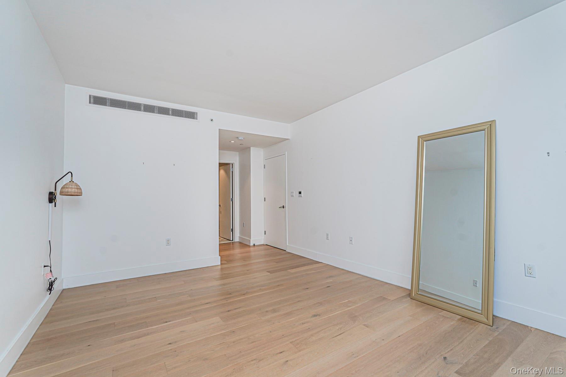 133 Beach 116th Street, Unit 2C Queens, NY 11694 - Photo 23 of 35 wooden floor in an empty room
