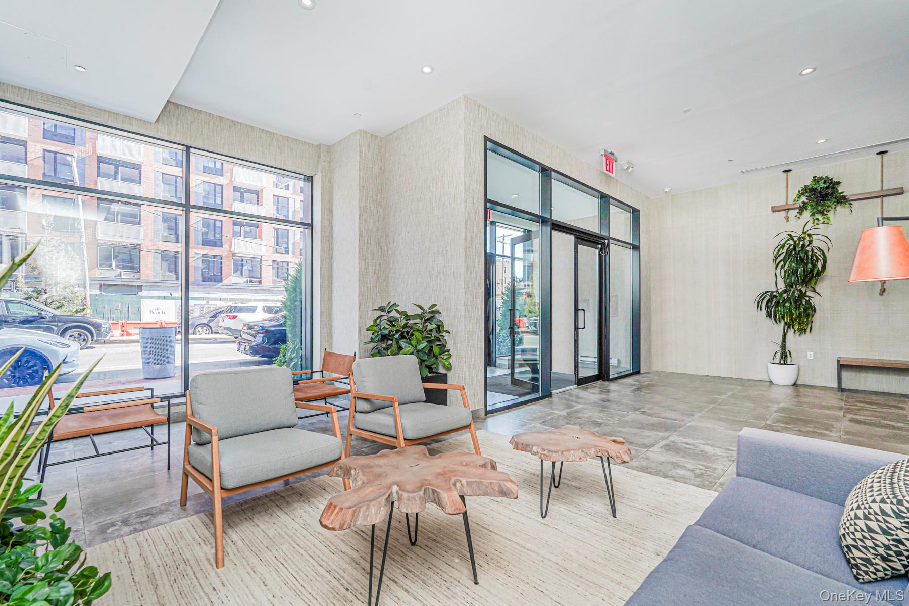 133 Beach 116th Street, Unit 2C Queens, NY 11694 - Photo 3 of 35 a living room with furniture and a large window